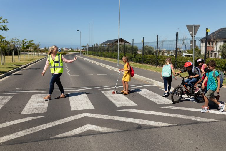 Woman wearing a high visibility vest on a pedestrian crossing